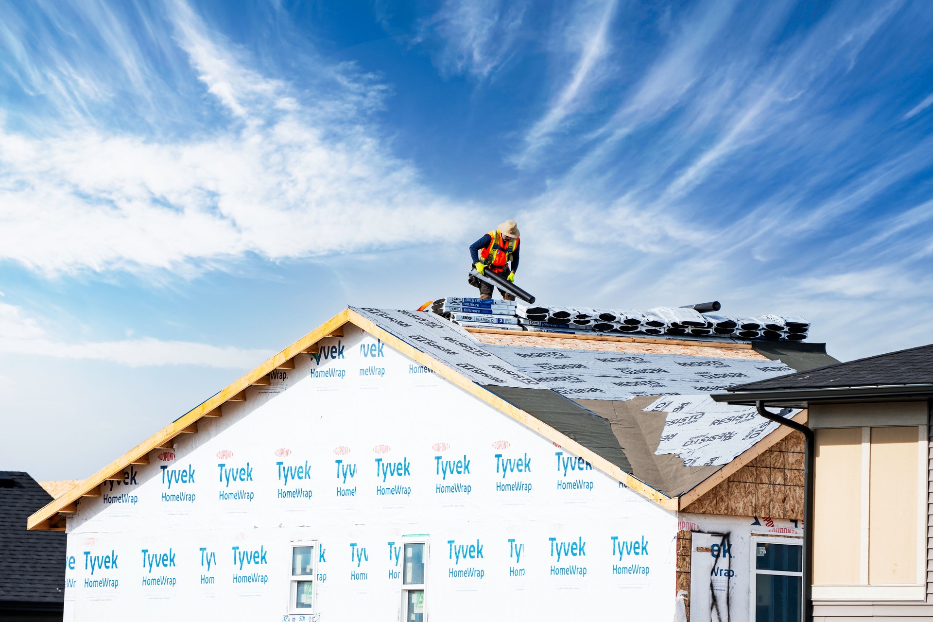 Roofer at work on a new home under construction.